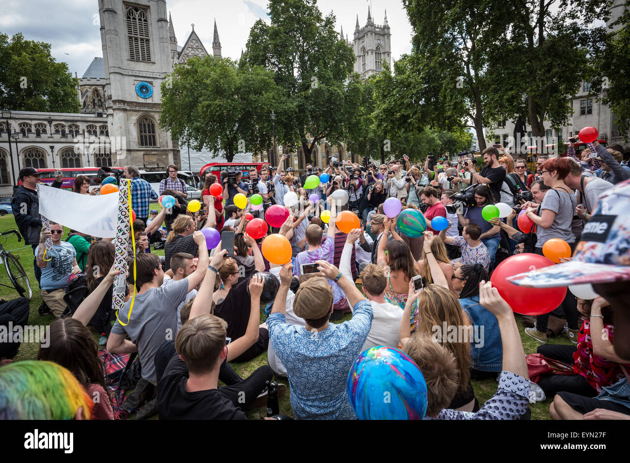 London, UK. 1st August, 2015. Campaigners inhale balloons inflated with nitrous oxide, commonly known as “laughing gas” to get high during a protest in Westminster’s Parliament Square against a proposed bill that aims to make selling any psychoactive substance illegal. Credit: Guy Corbishley/Alamy Live News Stock Photo