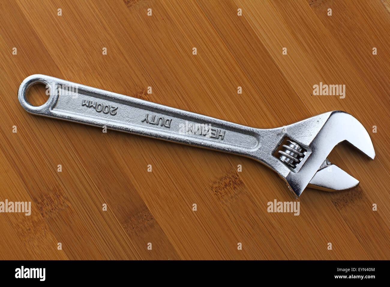 shiny Adjustable wrench on a wooden table Stock Photo