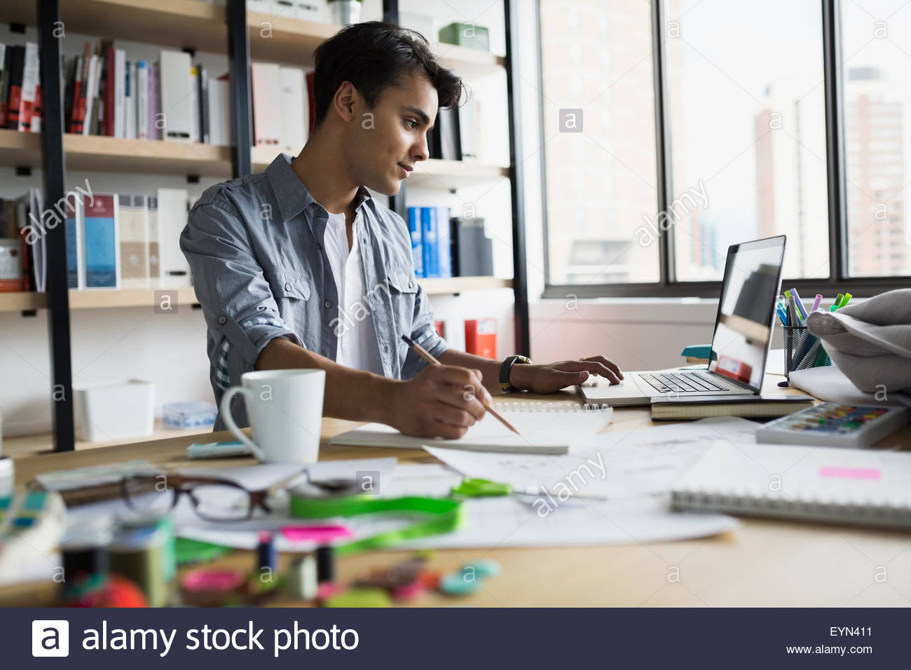 Architect working at laptop in office Stock Photo