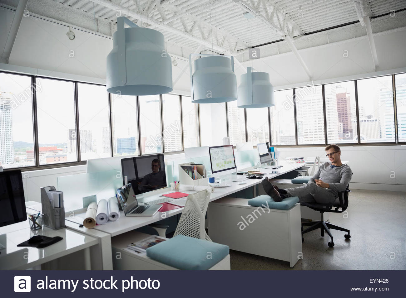 Architect with feet up in office Stock Photo