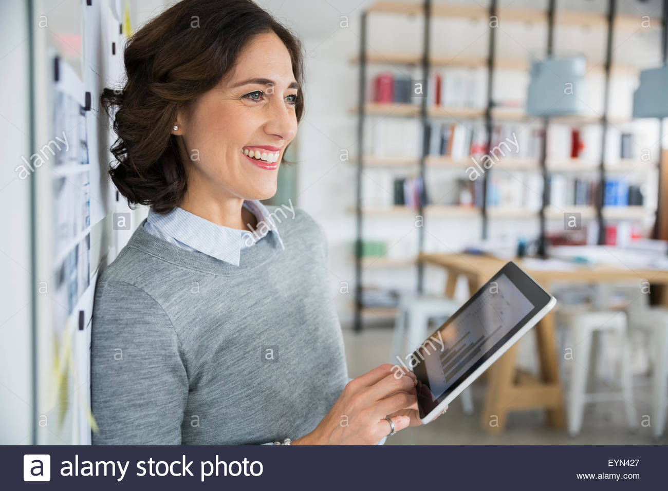 Smiling architect holding digital tablet in office Stock Photo