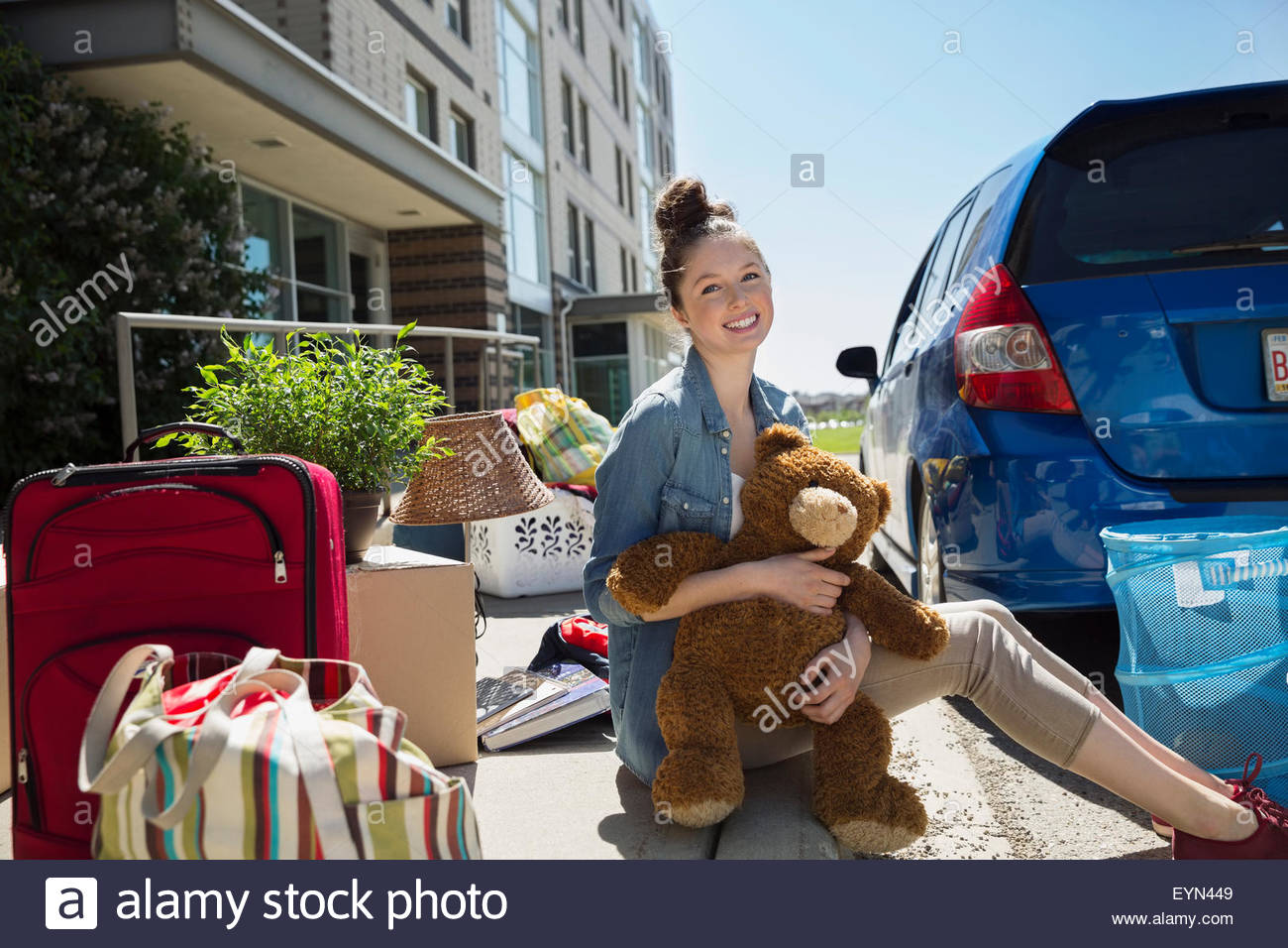 Portrait college student teddy bear moving into dorm Stock Photo