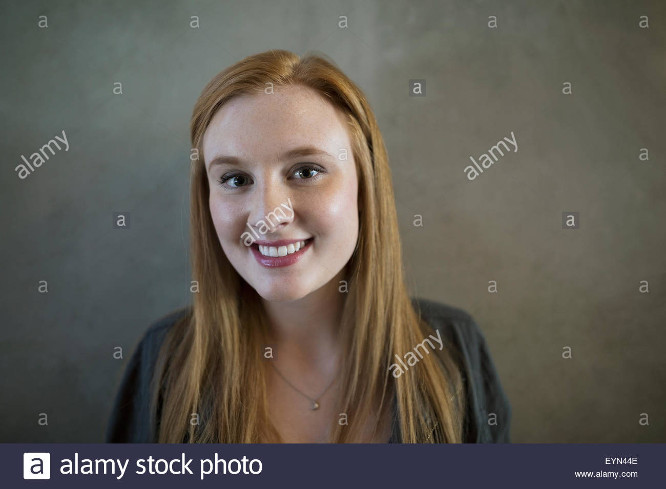 Portrait smiling young woman with red hair Stock Photo