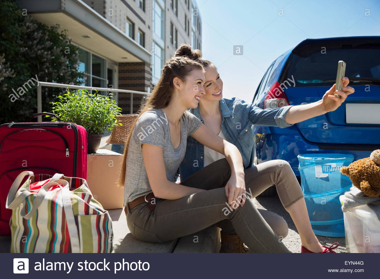 College students taking selfie moving into college dorm Stock Photo