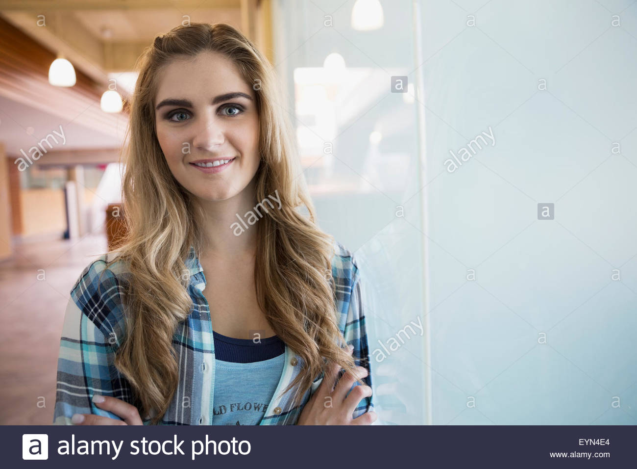 Portrait confident young blonde woman at window Stock Photo