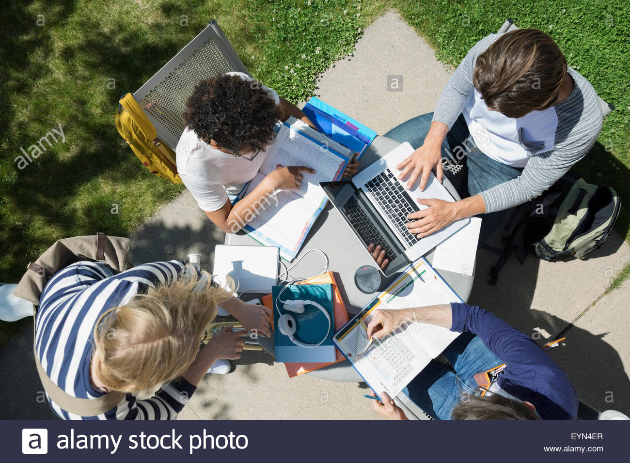 Overhead view college students studying at table Stock Photo