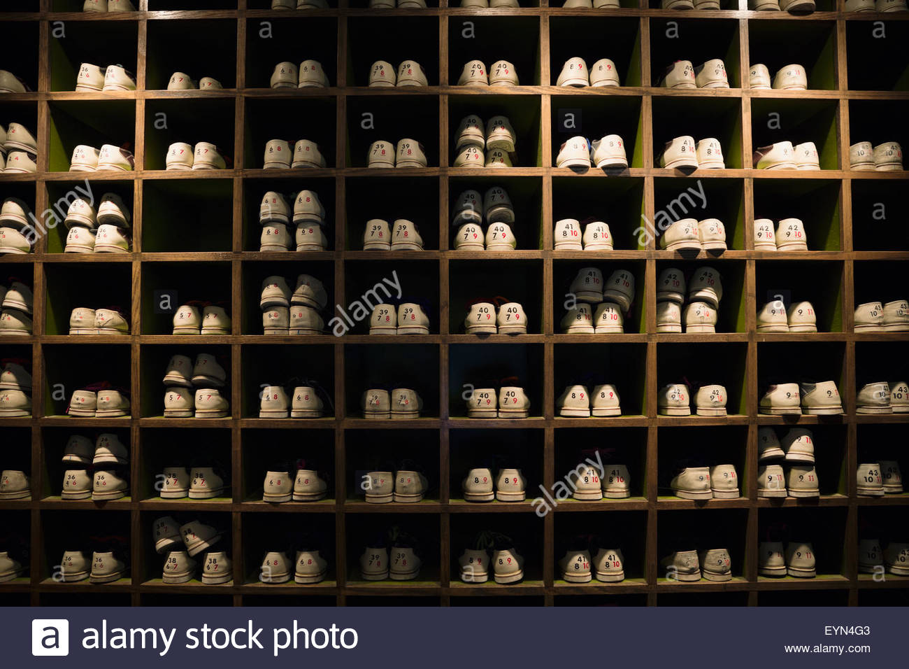 bowling shoes organized in cubby shelves bowling alley Stock Photo Alamy