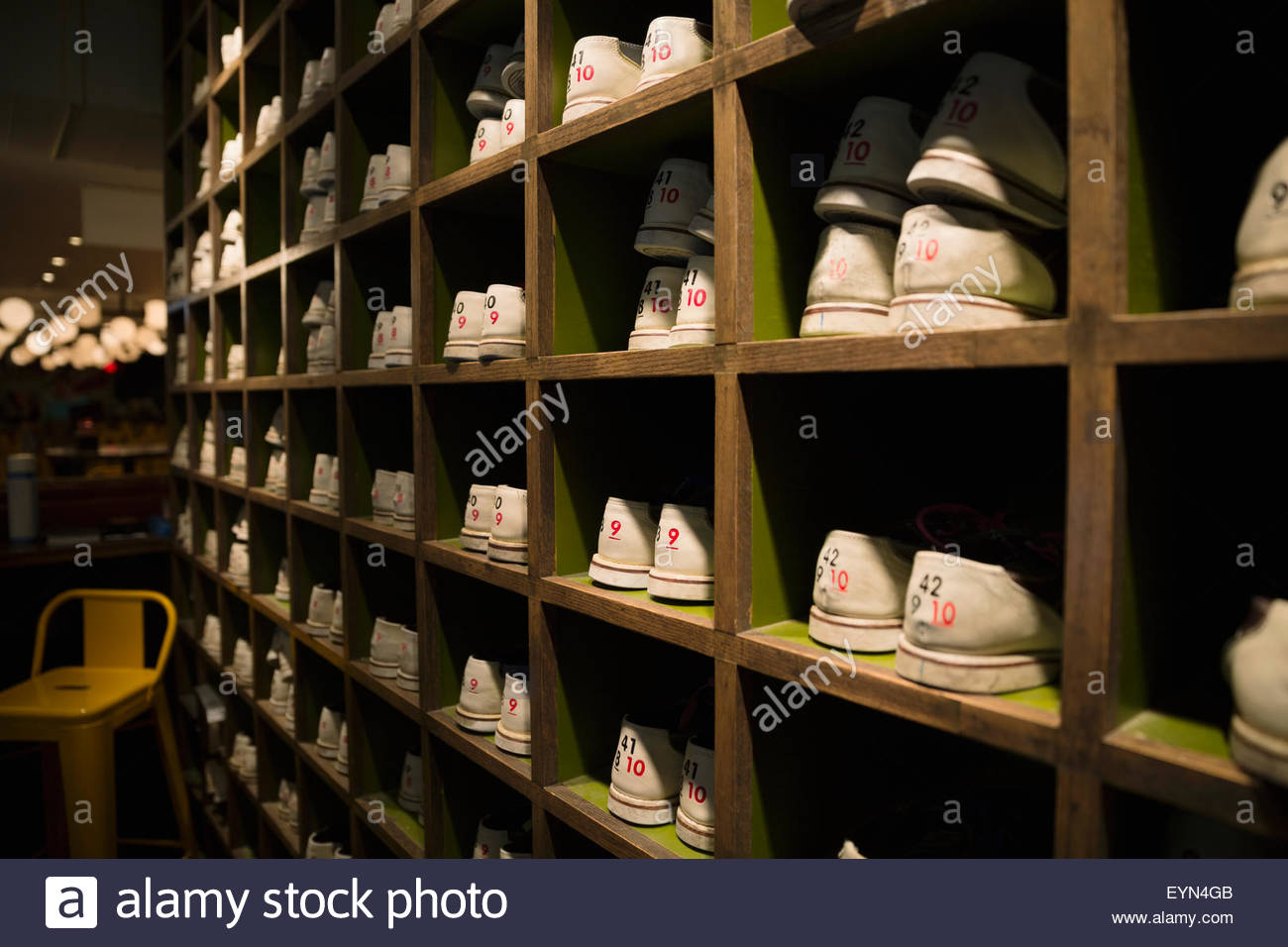 bowling shoes organized in cubby shelves bowling alley Stock Photo