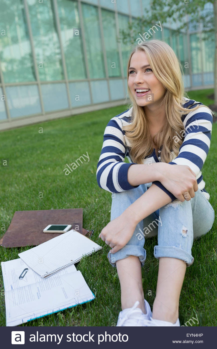 Girl sitting knees up smiling hi-res stock photography and images - Alamy