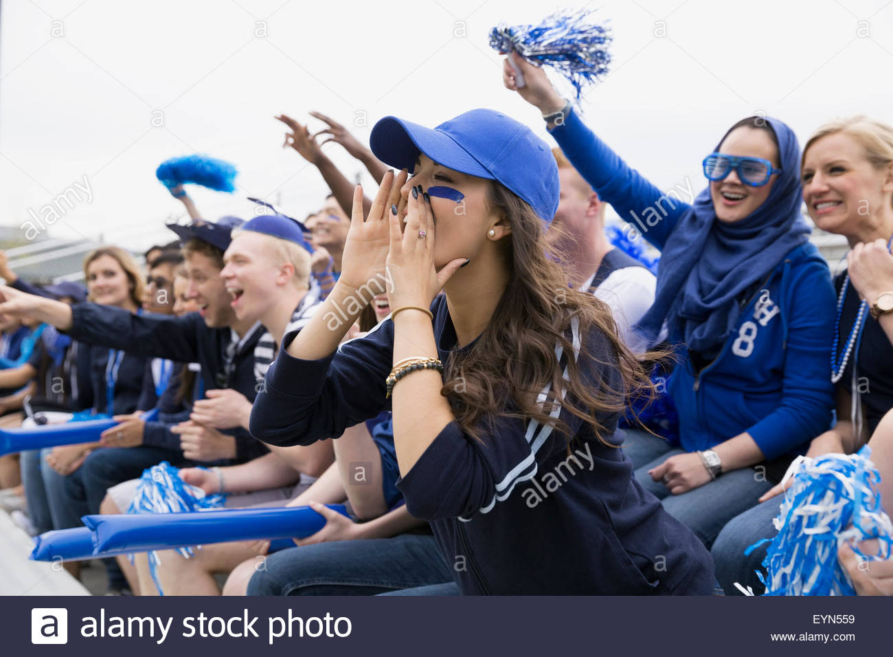 Fan in blue screaming from bleachers sports event Stock Photo