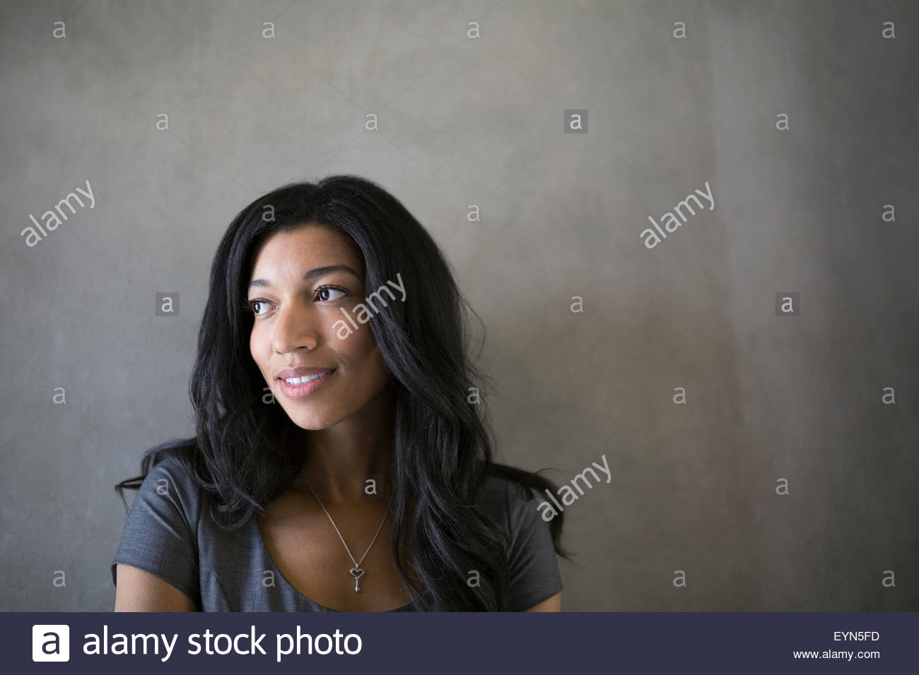 Pensive businesswoman with black hair looking away Stock Photo