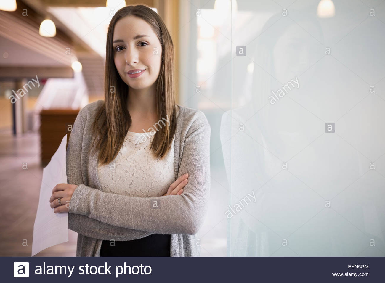 Portrait confident businesswoman with arms crossed frosted glass Stock Photo