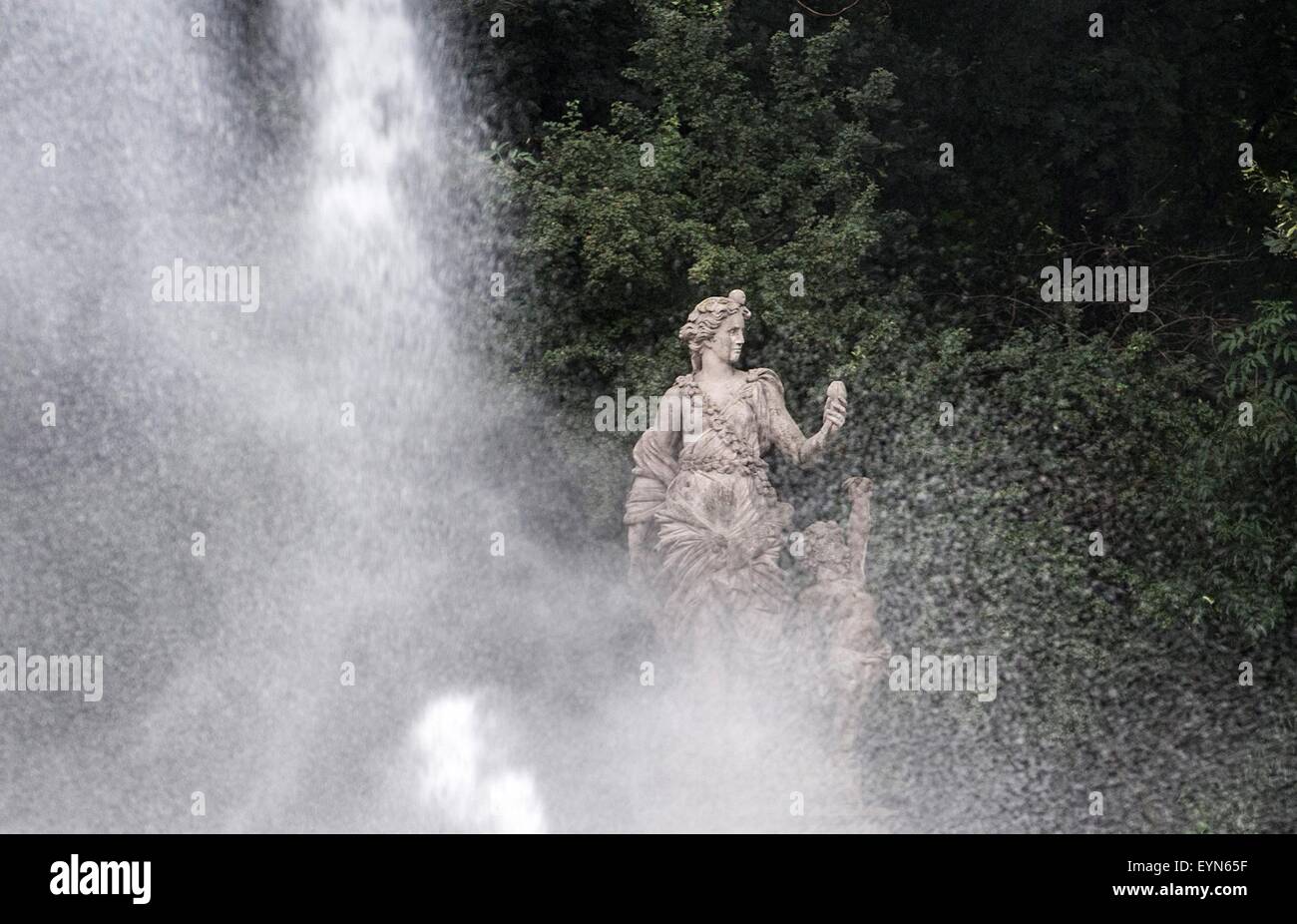 Water sprays cascade around a statue of the goddess Flora in a rose garden in Berlin, Germany, 30 July 2015. Despite rainfall in the past days, the sprinklers in the Tiergarten have been put to use. Photo: Paul Zinken Stock Photo