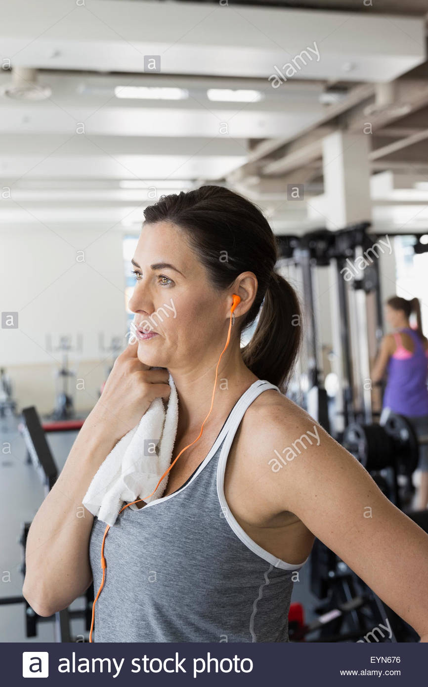 Woman with towel resting at gym Stock Photo
