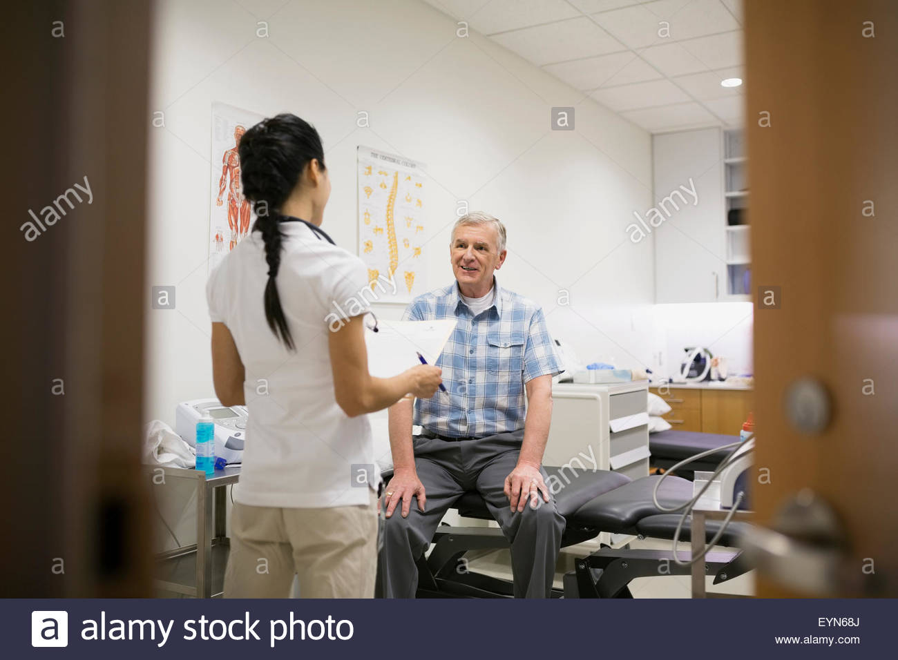 Physical therapist and patient talking in examination room Stock Photo