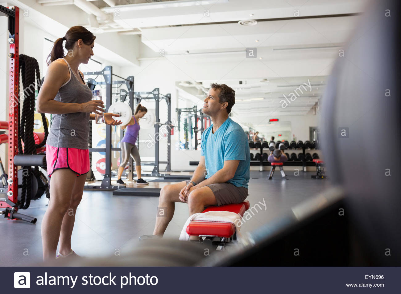 Man and woman talking at gym Stock Photo