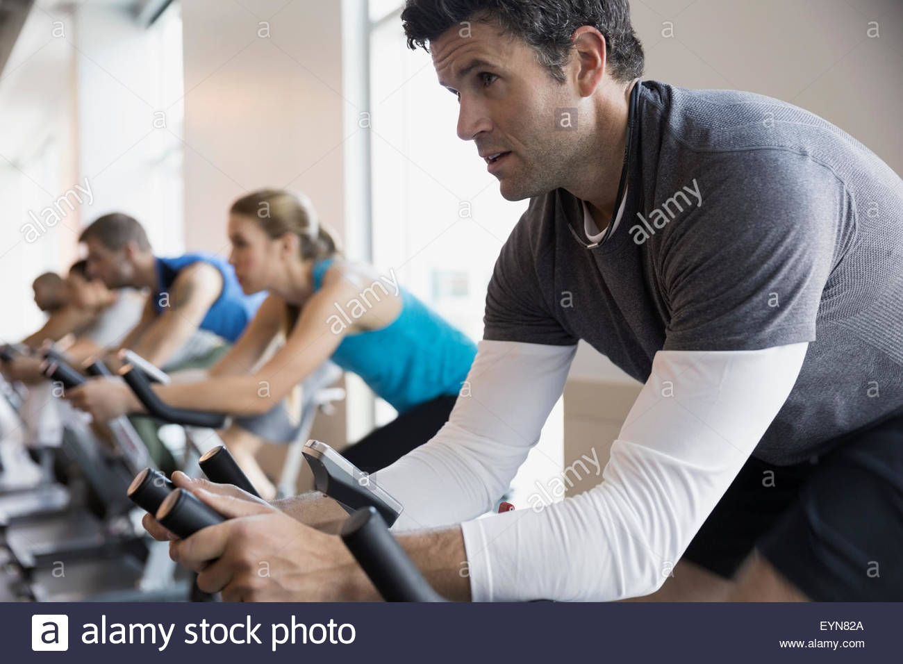 Focused man on stationary bike in spin class Stock Photo Alamy