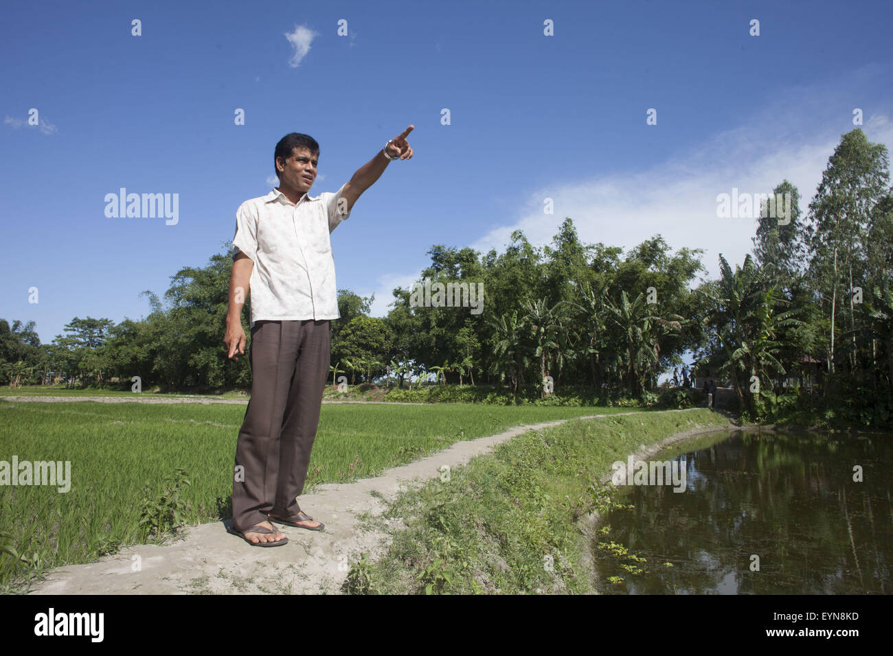 Bangladesh. 30th July, 2015. Rabbul Alam, who lives in the Indian enclave of Dahala Khagrabari, shows the enclaves boundary at Dalaha-Khagrabari Khagrabari in the Bangladeshi district of Panchagarh, on July 30, 2015. Bangladesh and India will this week finally swap tiny islands of land, ending one of the world's most difficult border disputes that has kept thousands of people in stateless limbo for almost 70 years. © Suvra Kanti Das/ZUMA Wire/Alamy Live News Stock Photo