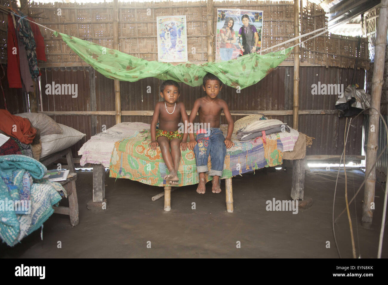Bangladesh. 30th July, 2015. Shantona (L), 5, and Durjay (R), 6, poses for portrait inside of their house at Dalaha-Khagrabari in the Bangladeshi district of Panchagarh, on July 30, 2015. Bangladesh and India will this week finally swap tiny islands of land, ending one of the world's most difficult border disputes that have kept thousands of people in stateless limbo for almost 70 years. © Suvra Kanti Das/ZUMA Wire/Alamy Live News Stock Photo