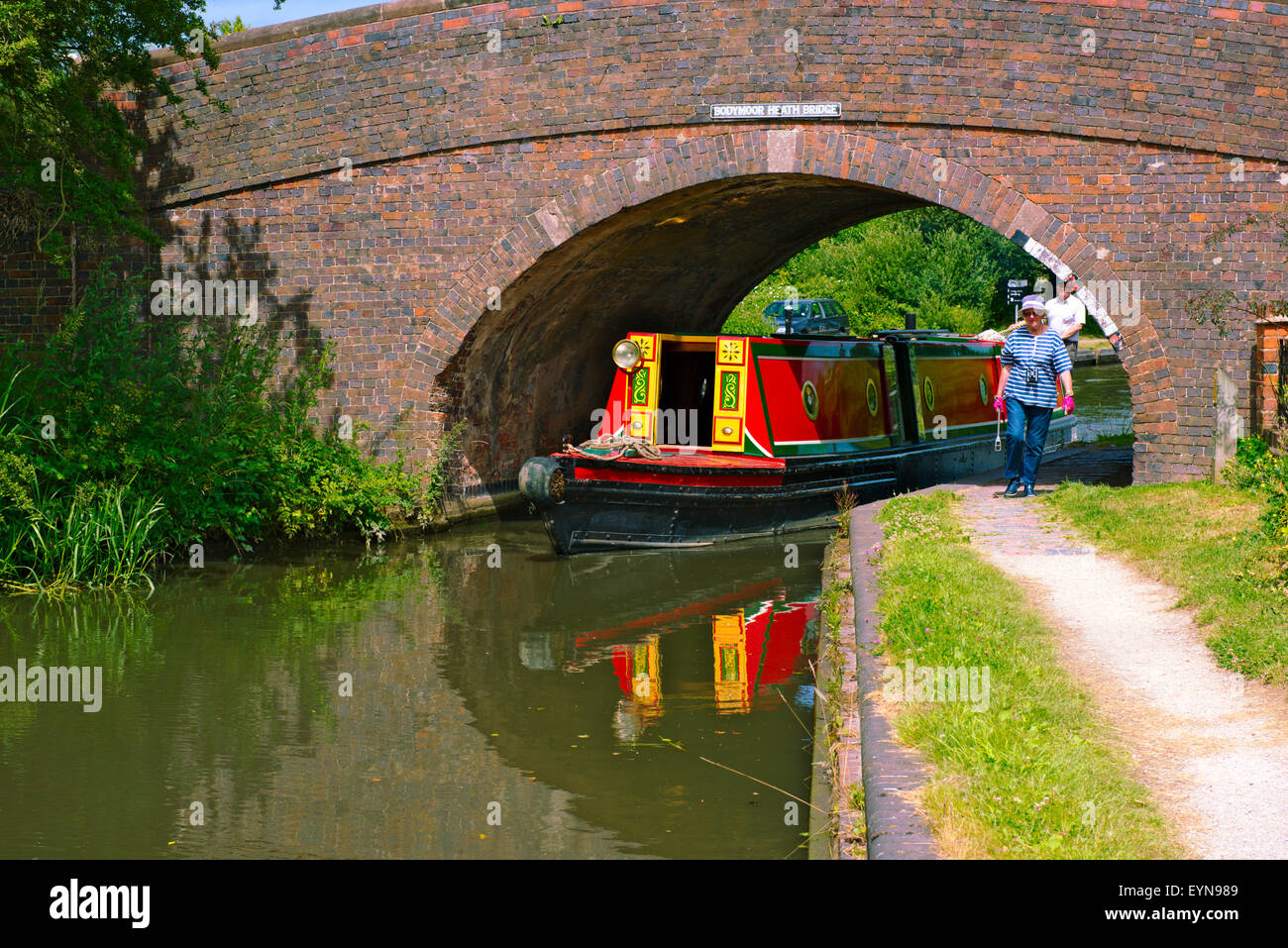 Canal narrow boat going under bridge on Birmingham and Fazeley Canal