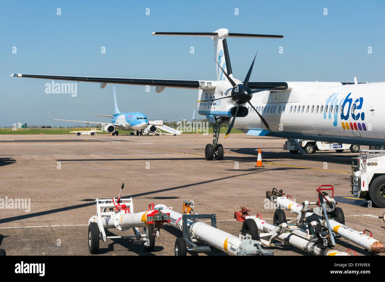 Aircraft tow bars on the apron at East Midlands Airport next to a Flybe