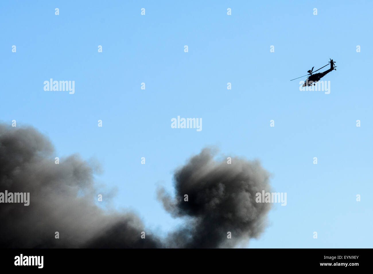 Army Air Corps Apache AH1 attack helicopter and black smoke seen during a forces role demonstration Stock Photo