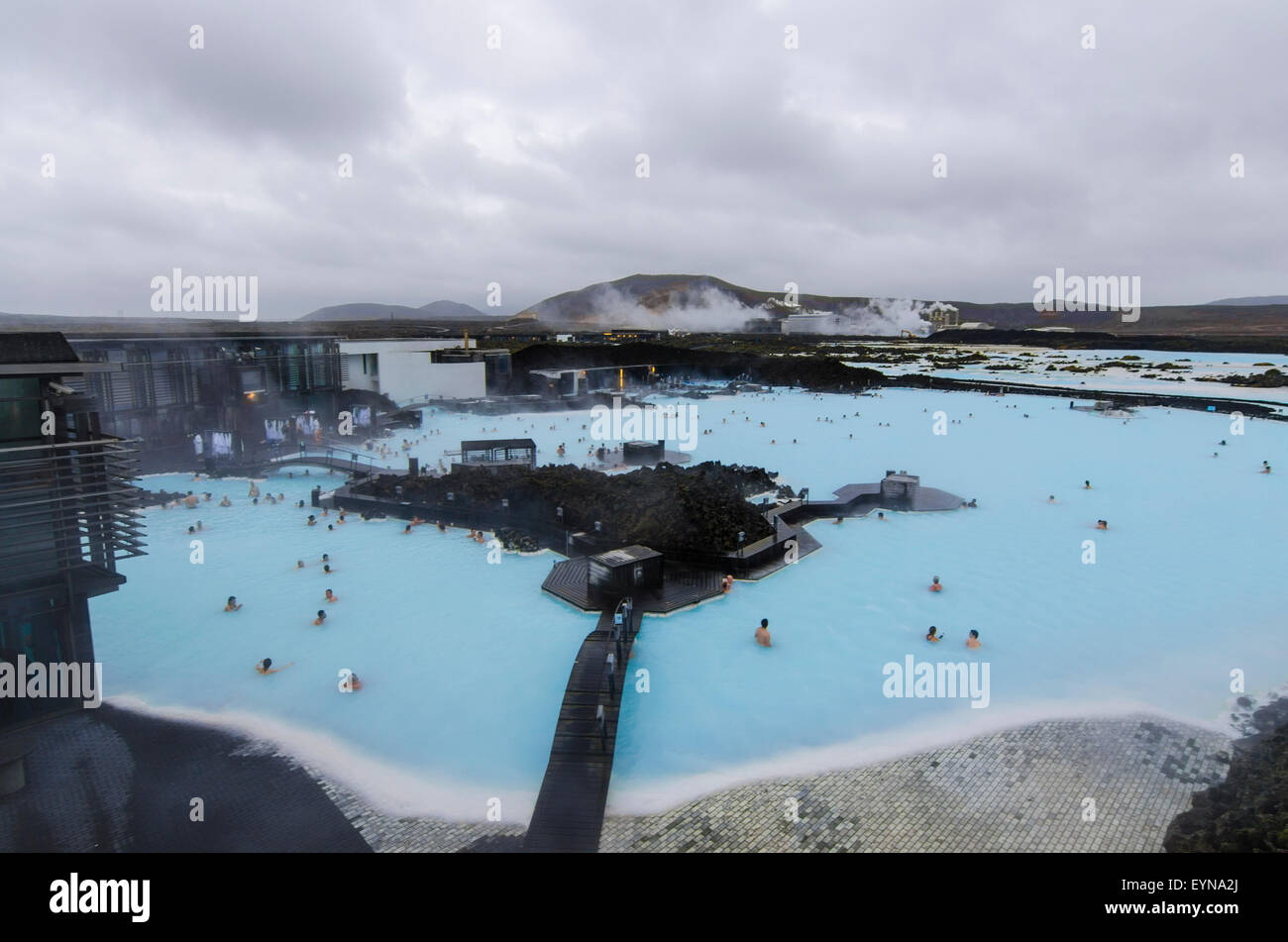 Blue Lagoon Geothermal Spa with Geothermal Powerplant in Background, Iceland Stock Photo