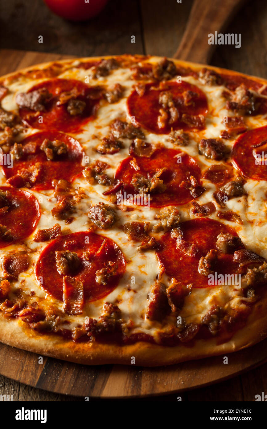 Homemade Meat Loves Pizza with Pepperoni Sausage and Bacon Stock Photo