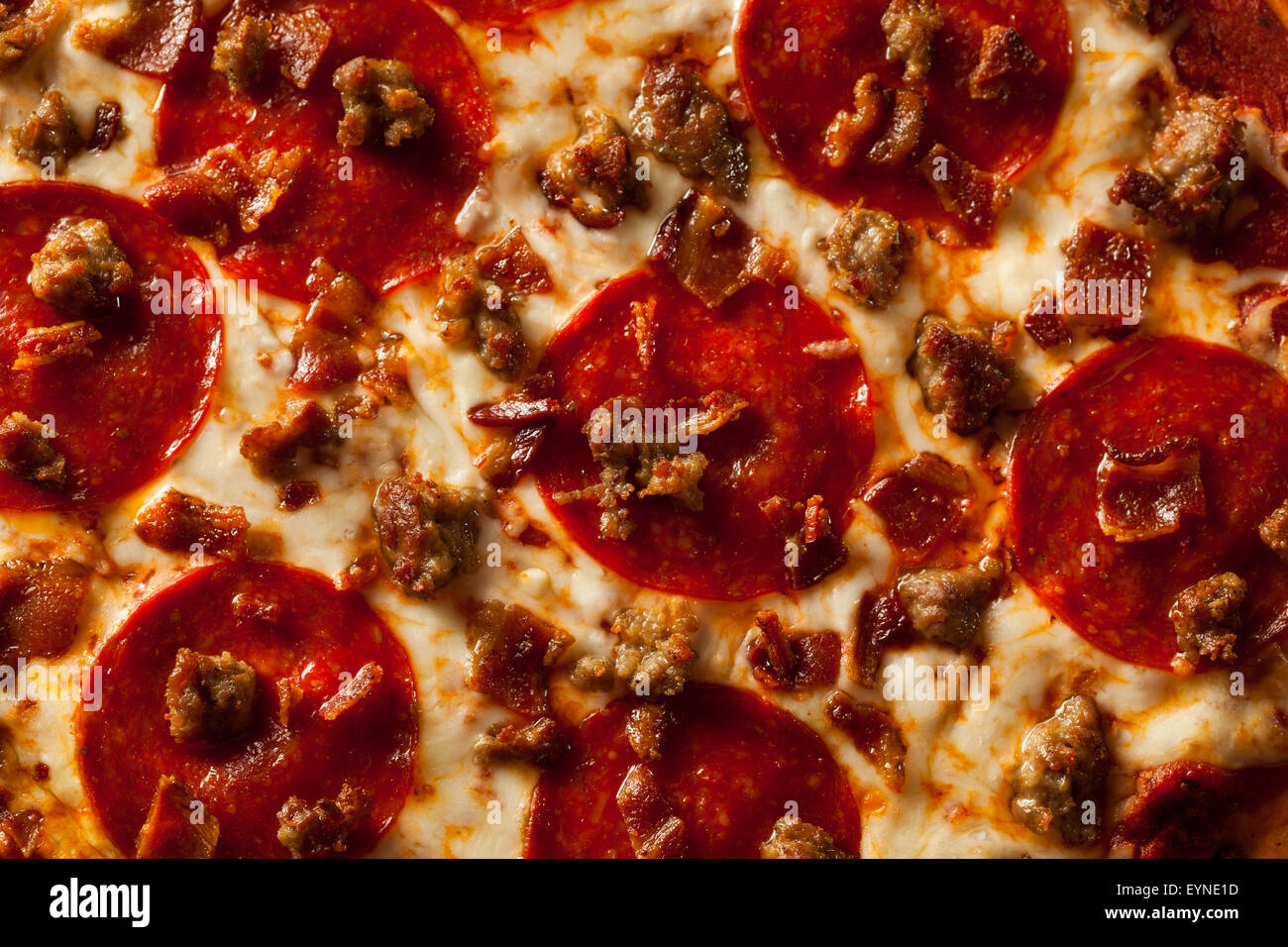 Homemade Meat Loves Pizza with Pepperoni Sausage and Bacon Stock Photo