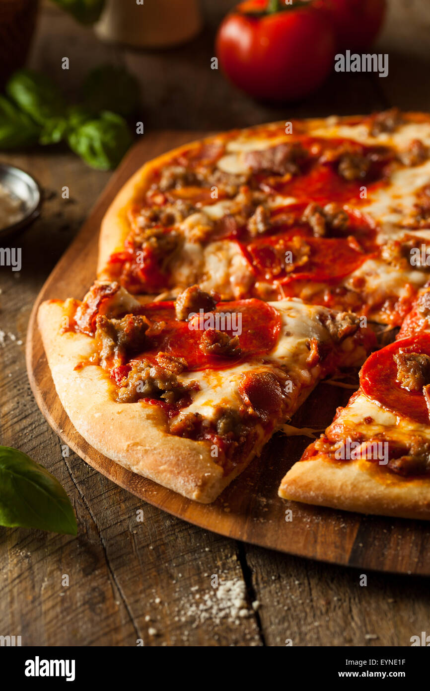 Homemade Meat Loves Pizza with Pepperoni Sausage and Bacon Stock Photo