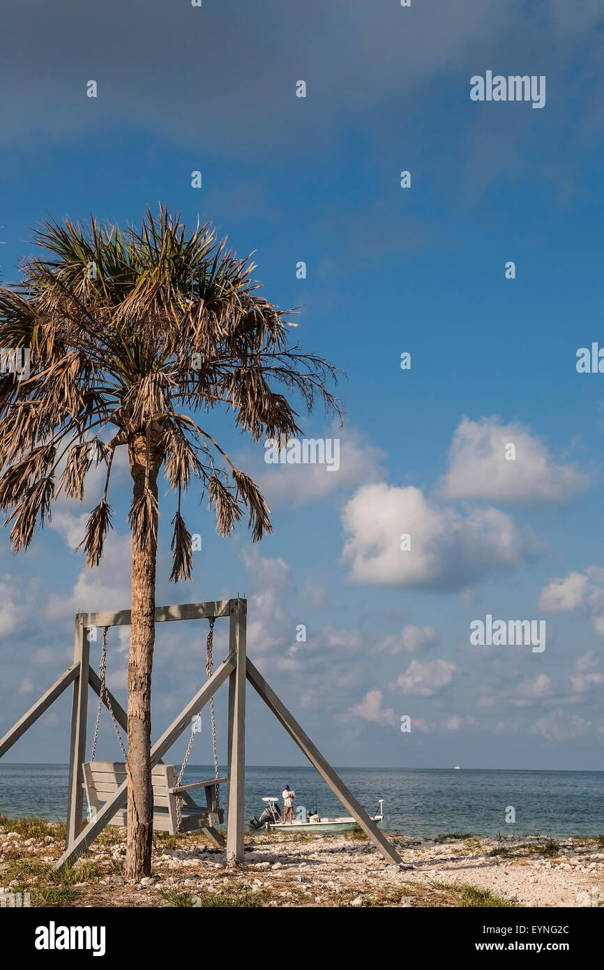 A typical Florida scene. A swing, a beach, a man fishing, Honeymoon