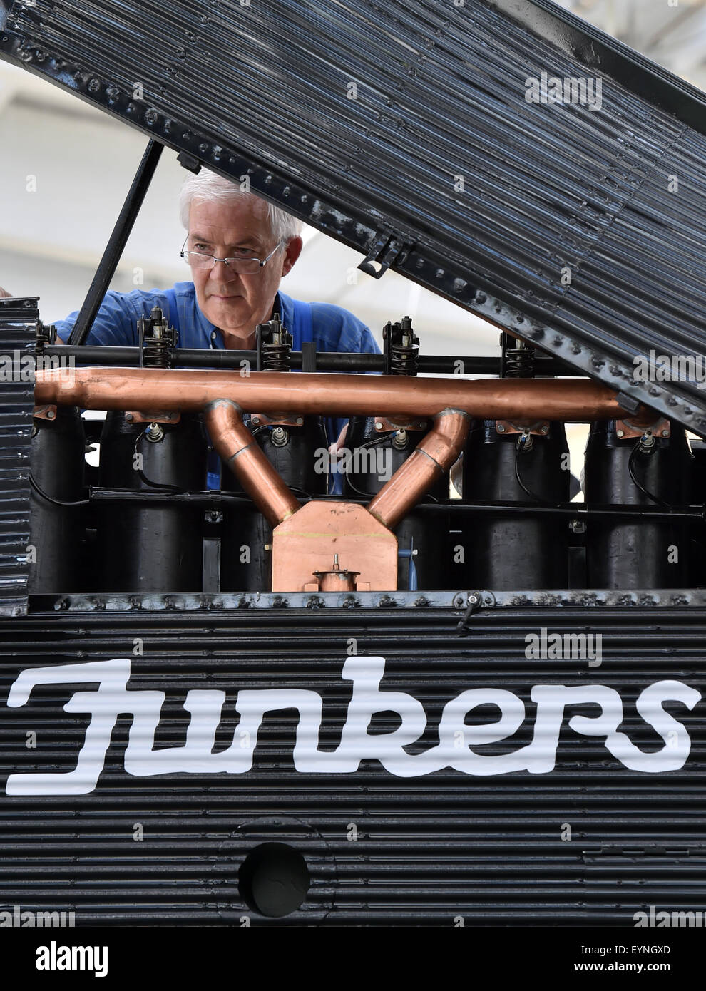 Dessau, Germany. 21st July, 2015. Rolf Maerz of the seniors' work group of the Technikmuseums Hugo Junkers (Hugo Junkers technical museum) working on their latest creation: an accurate recomstruction of the world's first all-metal civilian aircraft - a Junkers F13 - albeit without a functioning motor, in Dessau, Germany, 21 July 2015. PHOTO: HENDRIK SCHMIDT/DPA/Alamy Live News Stock Photo