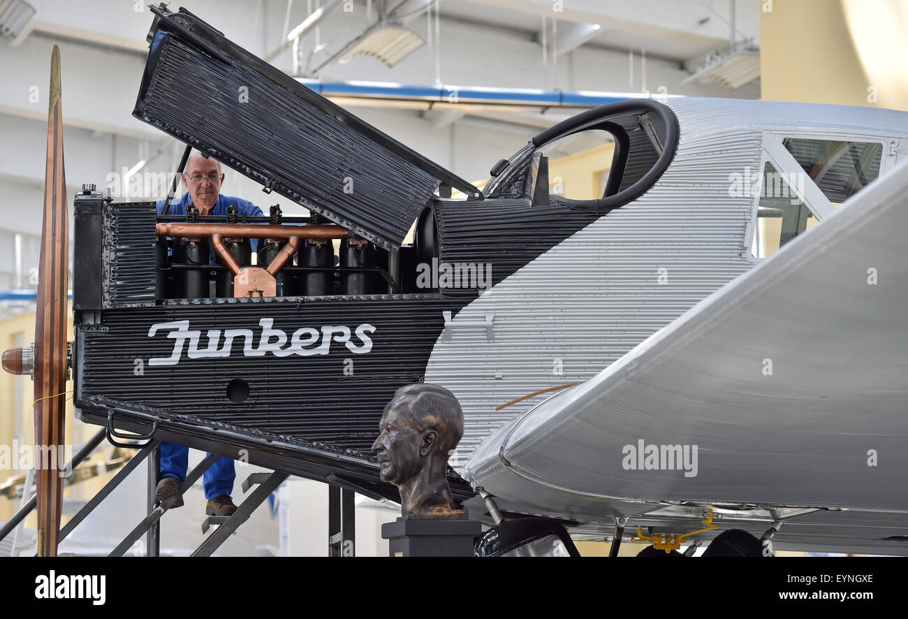 Dessau, Germany. 21st July, 2015. Rolf Maerz of the seniors' work group of the Technikmuseums Hugo Junkers (Hugo Junkers technical museum) working on their latest creation: an accurate recomstruction of the world's first all-metal civilian aircraft - a Junkers F13 - albeit without a functioning motor, in Dessau, Germany, 21 July 2015. PHOTO: HENDRIK SCHMIDT/DPA/Alamy Live News Stock Photo