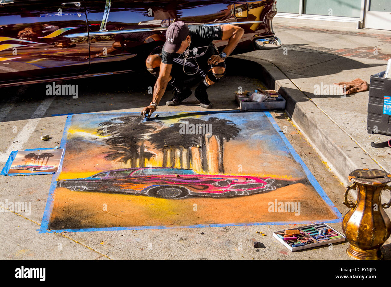 Burbank, CA USA, 01 AUG 2015 2005 Artist using chalk to do car pictures on the street at Burbank California Classic Car Show. Stock Photo