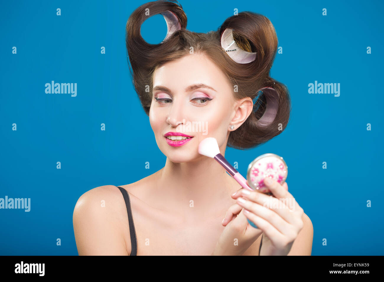 Cute pin up girl applying blusher Stock Photo: 85913221 - Alamy