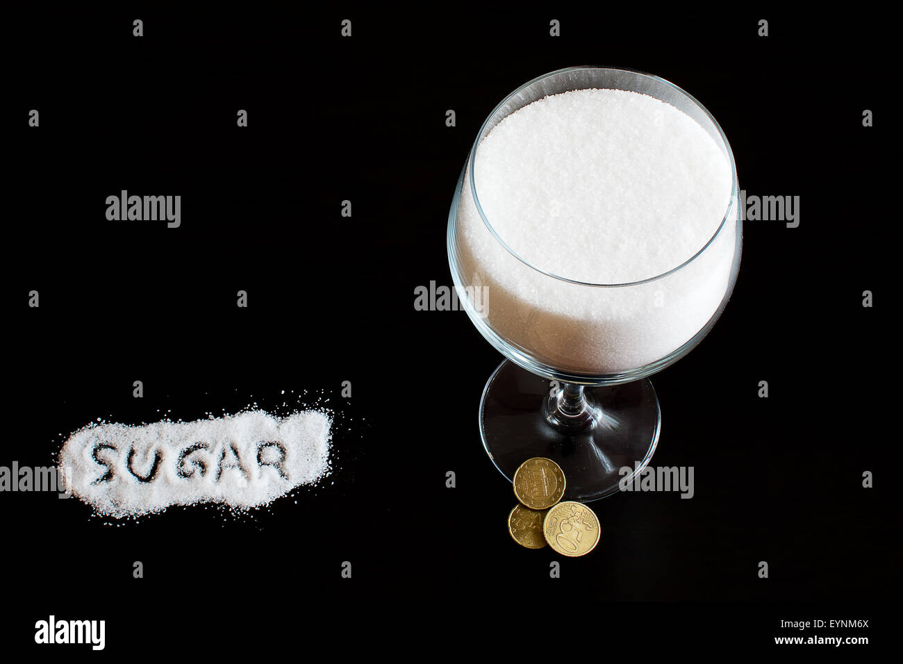 A cup of sugar and its cost Stock Photo