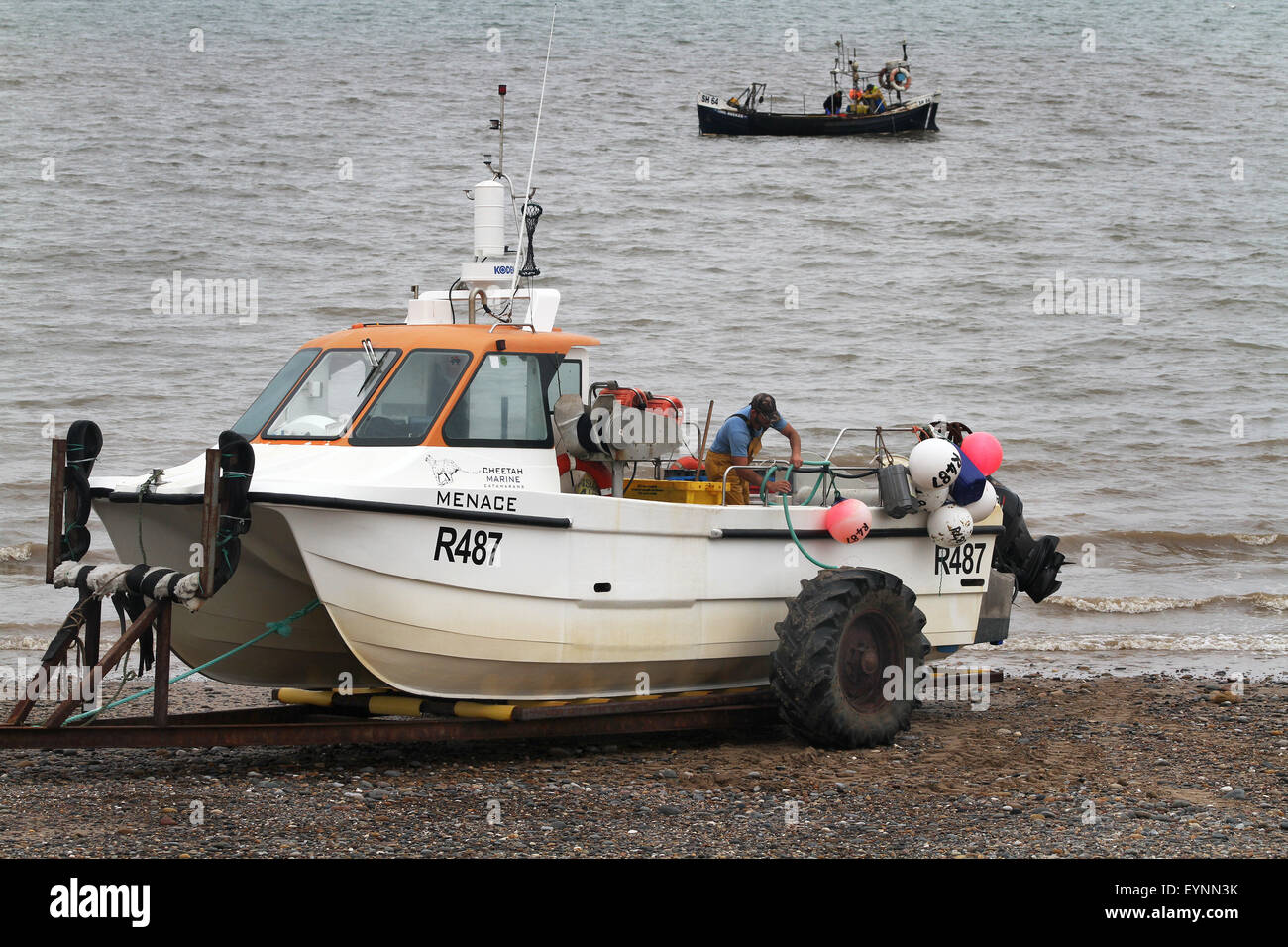 Fishing boats landing on the beach at Hornsea, east Yorkshire, UK Stock