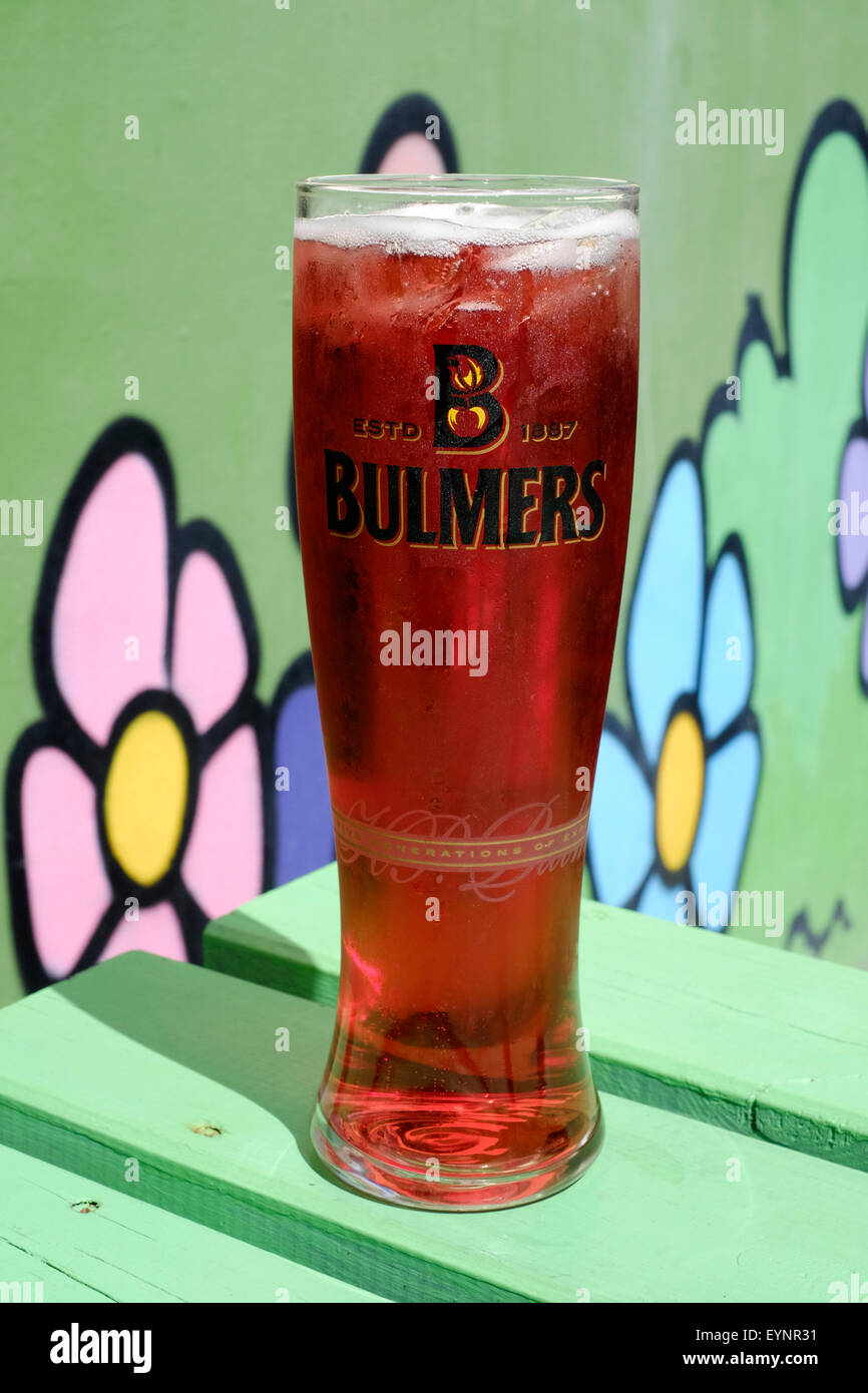 freshly poured pint of bulmers fruit cider sparkles in the sun whilst sat on a pub garden table Stock Photo