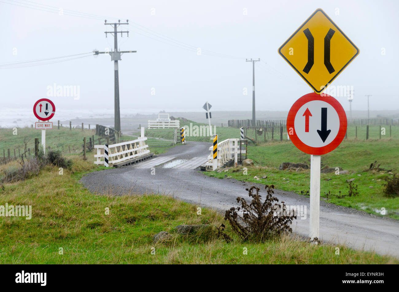 Road signs on gravel road with bridge, Glenburn, Wairarapa, North
