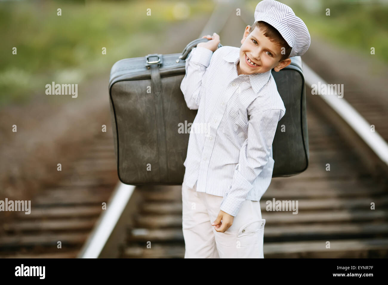 boy with suitcase on railroad Stock Photo Alamy