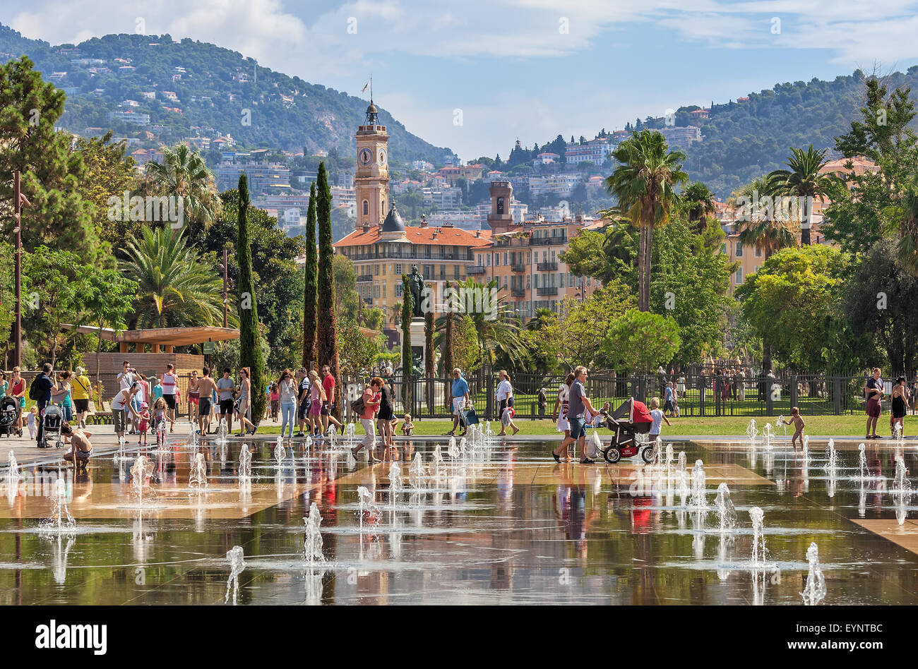 People among fountains at Promenade du Paillon in Nice, France. Stock Photo