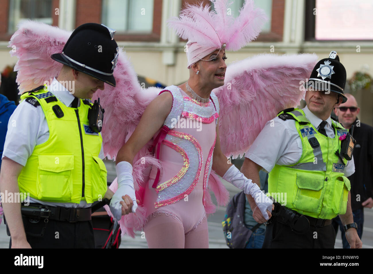 Stockton-on-Tees, UK, Saturday, 1st August, 2015. A male street performer, in full costume as a pink angel, interacts with two officers from Cleveland Police, dressed in their normal police uniform, at Instant Light, the 28th Stockton International Riverside Festival. Stock Photo