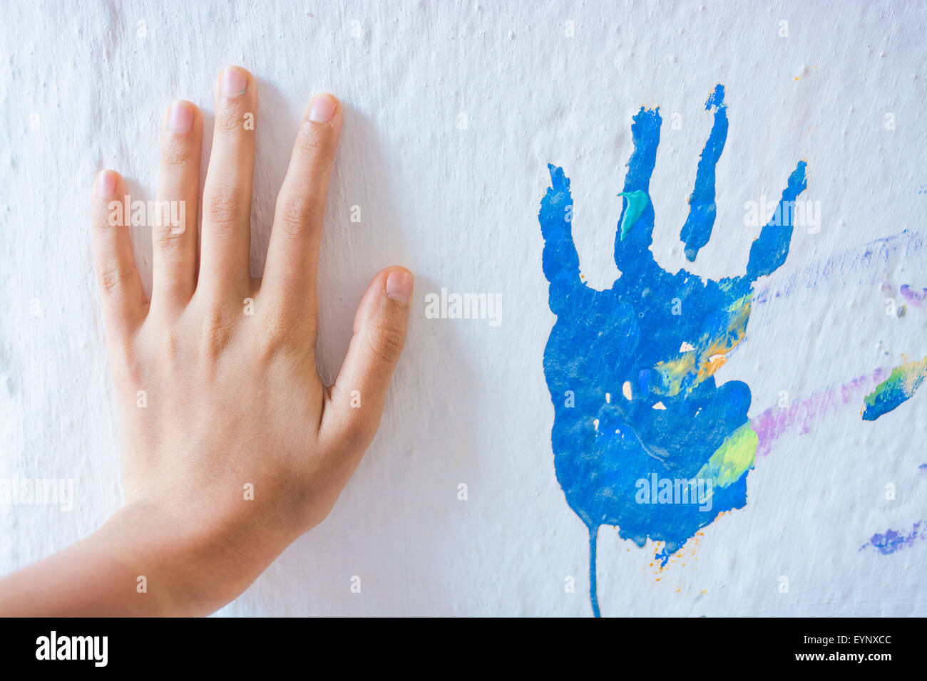Painting wall with hands Stock Photo
