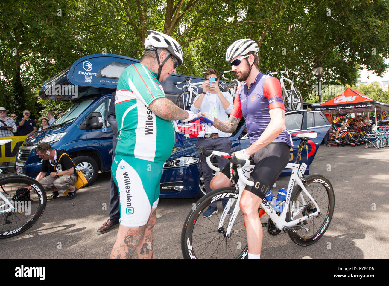 London, UK. 2nd Aug, 2015. Sir Bradley Wiggins signs a fan's cycling jersey before the Prudential RideLondon-Surrey Classic at Horse Guards Parade, London, United Kingdom on 2 August 2015. The race started at Horse Guards Parade and will finish on The Mall after a 200km route around Surrey and Greater London. Credit:  Andrew Peat/Alamy Live News Stock Photo