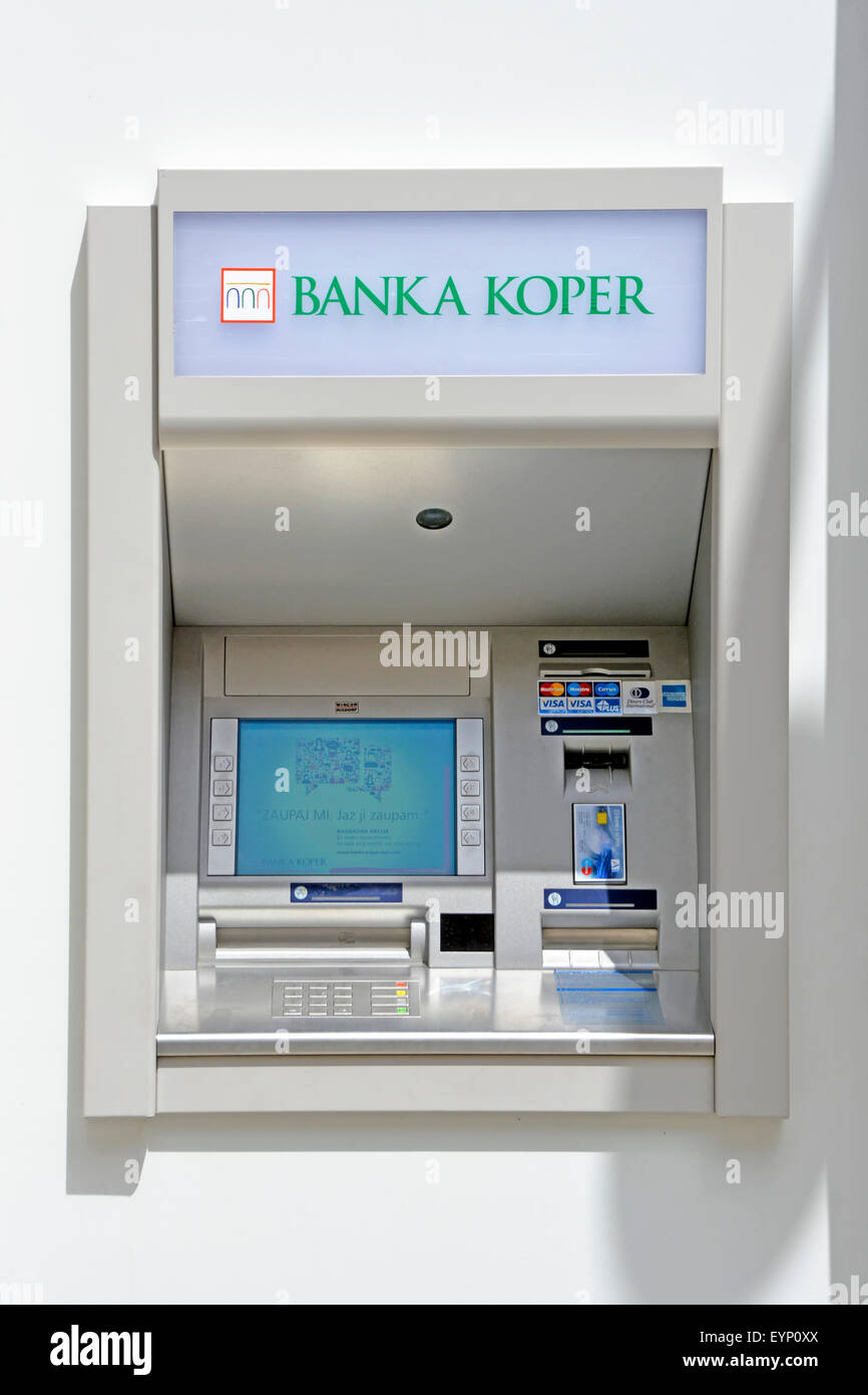 Koper Slovenia Bank ATM cash dispensing machine in wall of local foreign bank building in town square Slovenia, Istrian Peninsula, Stock Photo