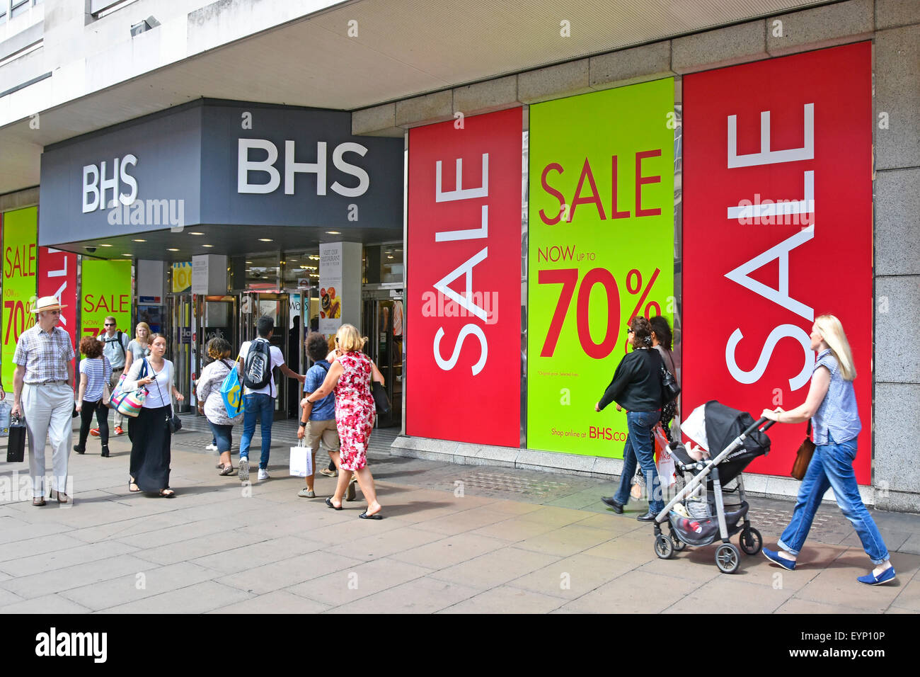 Oxford Street Shoppers and BHS store windows covered in summer sale discount posters Stock Photo