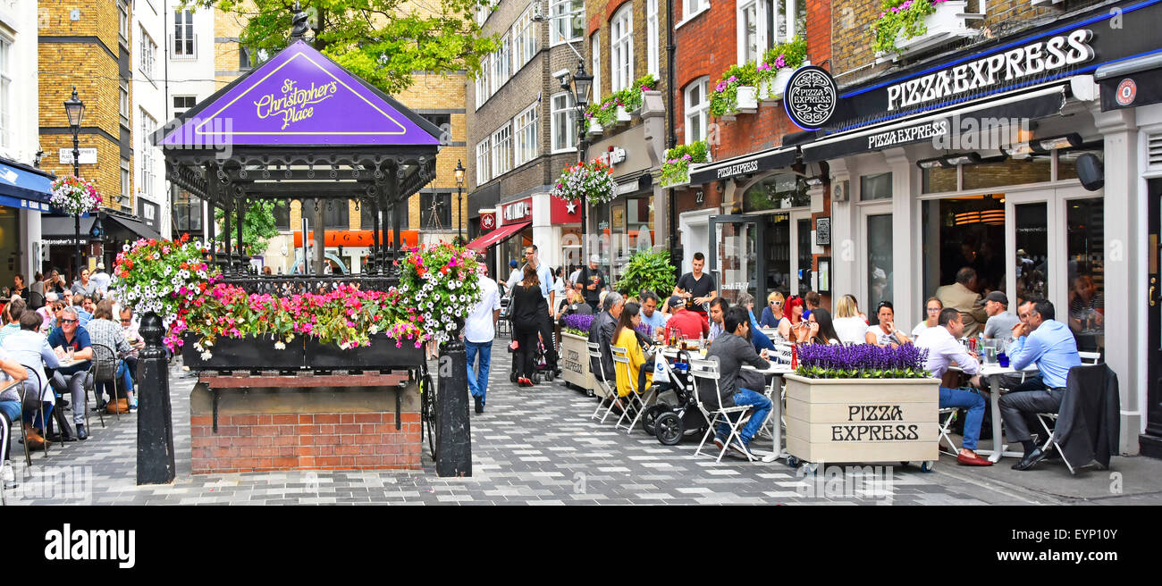 Pizza Express pizza restaurant with people eating out dining outdoors in St Christophers Place off Oxford Street alfresco dining London West End UK Stock Photo