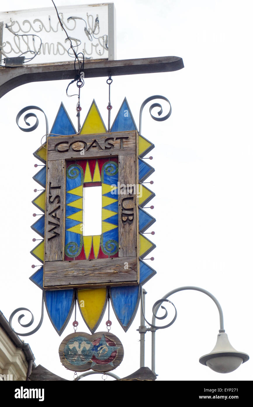 Wooden pub sign with the misspelling of the word west. Stock Photo