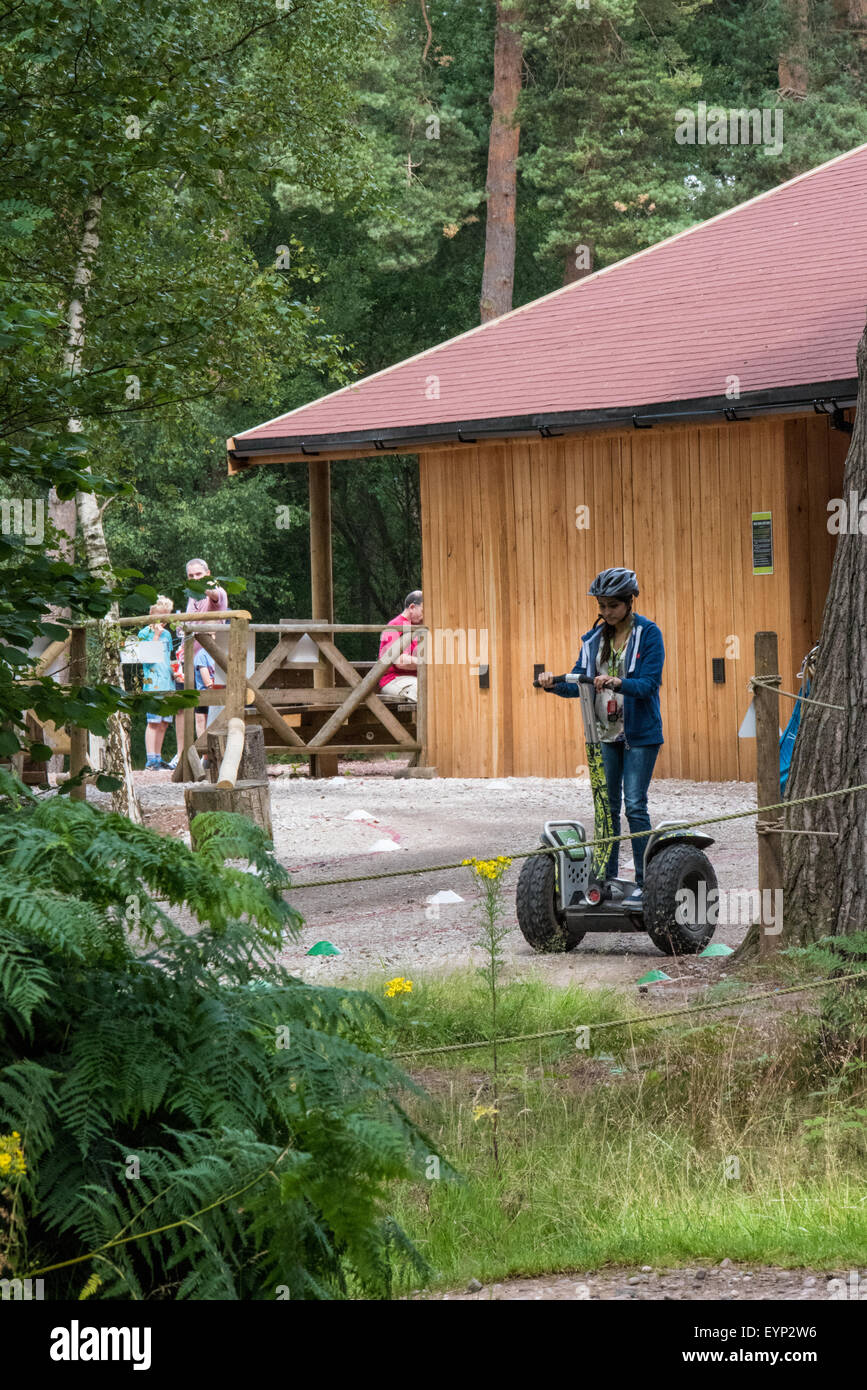 A girl learning to ride on a segway at Go Ape Activity Centre , Cannock Chase Staffordshire West Midlands UK Stock Photo