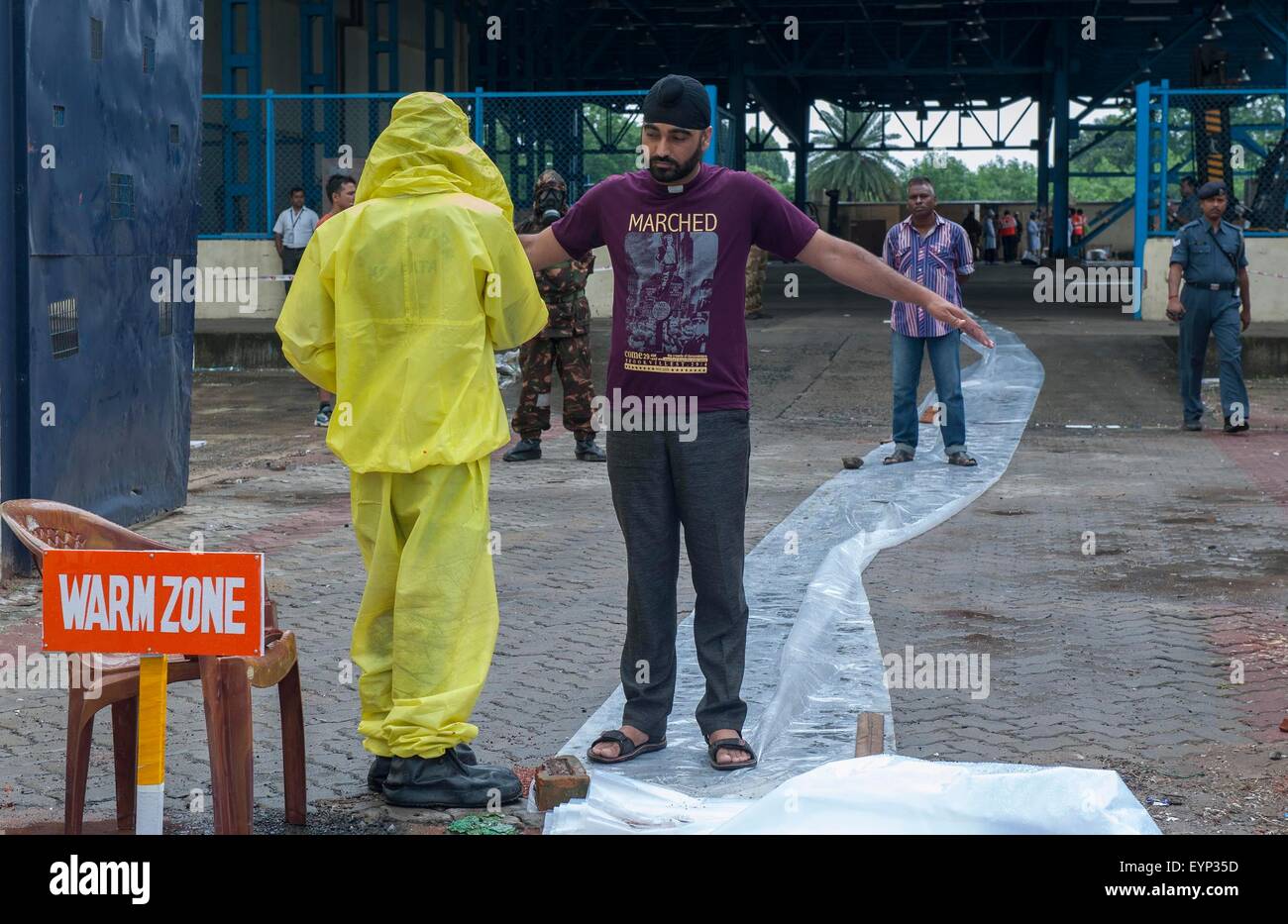 Kolkata, Indian state West Bengal. 2nd Aug, 2015. Indian security personnel take part in a drill on chemical, biological, radiological and nuclear emergency at cargo terminal of Netaji Subhas Chandra Bose International Airport in Kolkata, capital of eastern Indian state West Bengal, Aug. 2, 2015. National Disaster Response Force (NDRF), Airports Authority of India (AAI) and other disaster management group took part in this exercise. Credit:  Tumpa Mondal/Xinhua/Alamy Live News Stock Photo